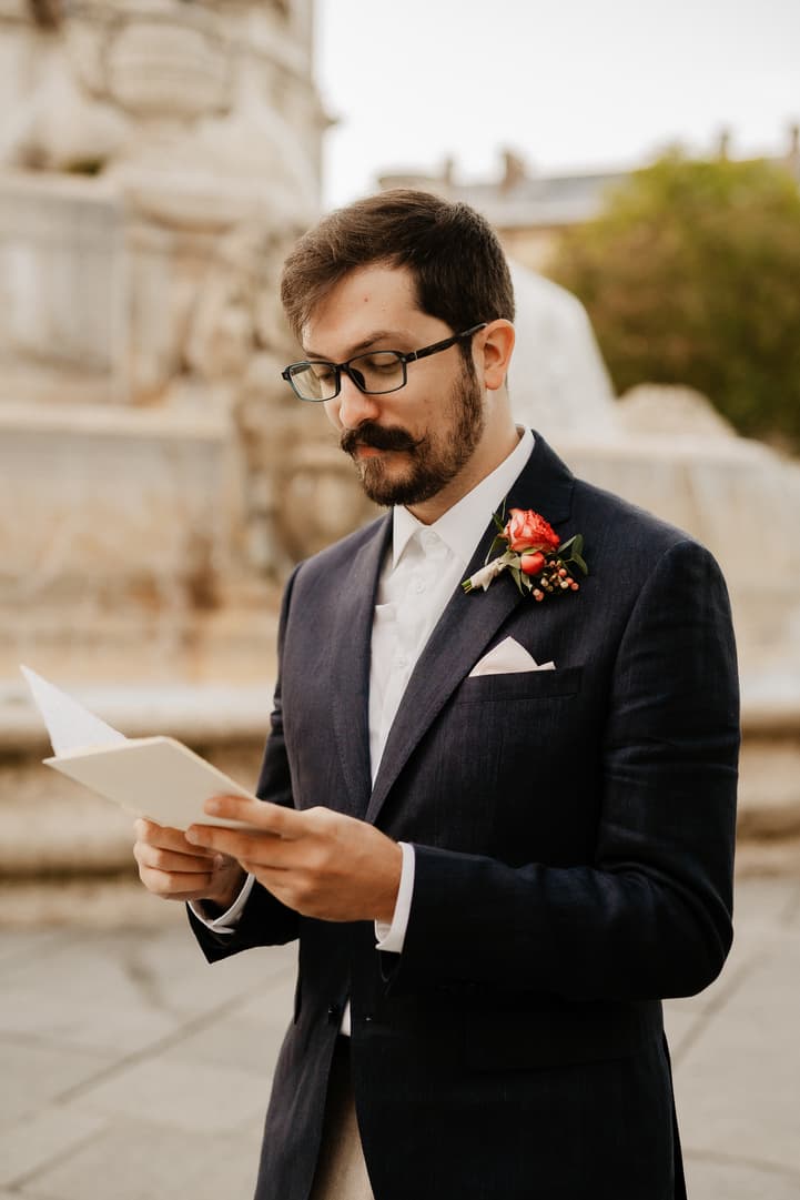 Florent reading his vows from a handwritten page