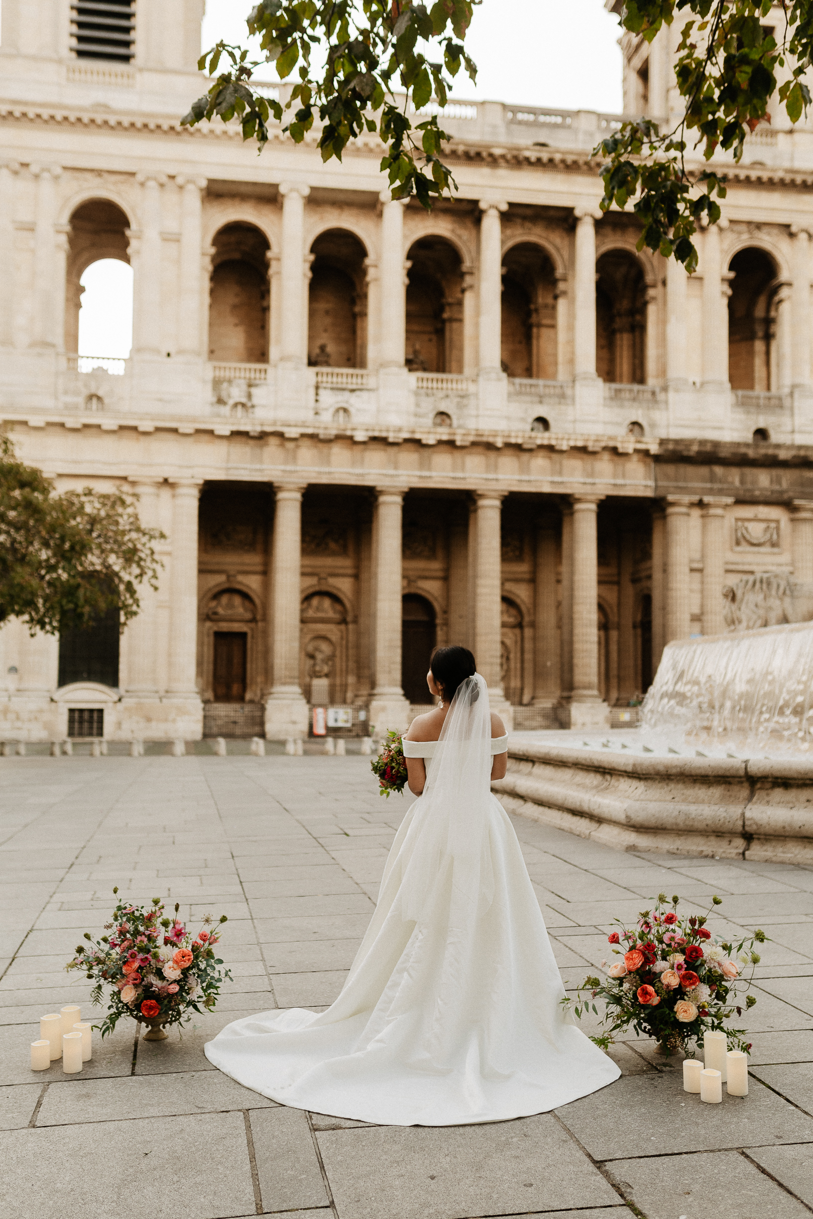 Haruka in her gown before the church of Saint-Sulpice, ceremony flowers on the square