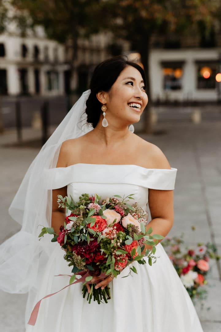 Haruka in her off-shoulder gown and veil, laughing with her bouquet