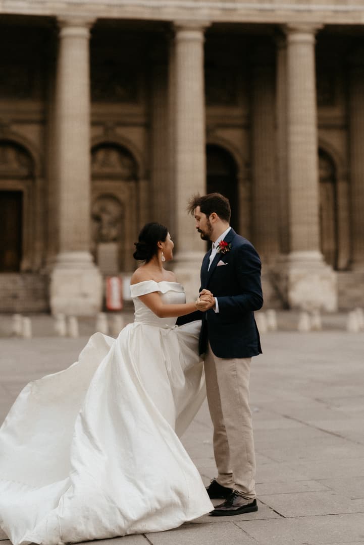 Haruka and Florent smiling at each other before the columns of Saint-Sulpice