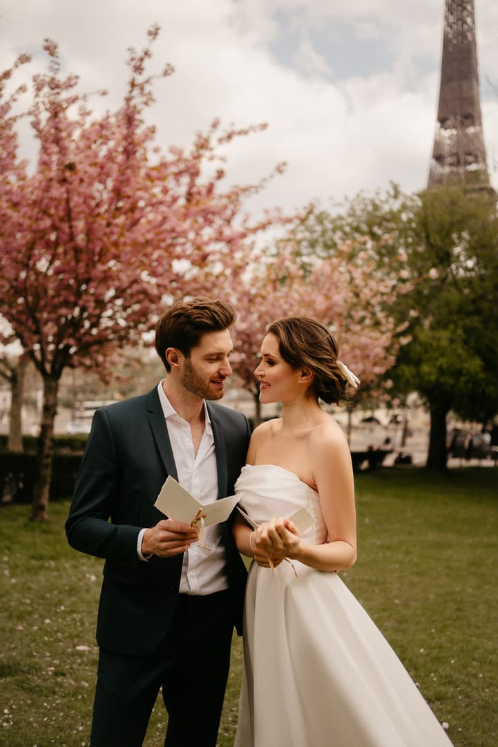 Cherry blossoms spring couple elopement wedding ceremony in eiffel tower Paris street photoshoot