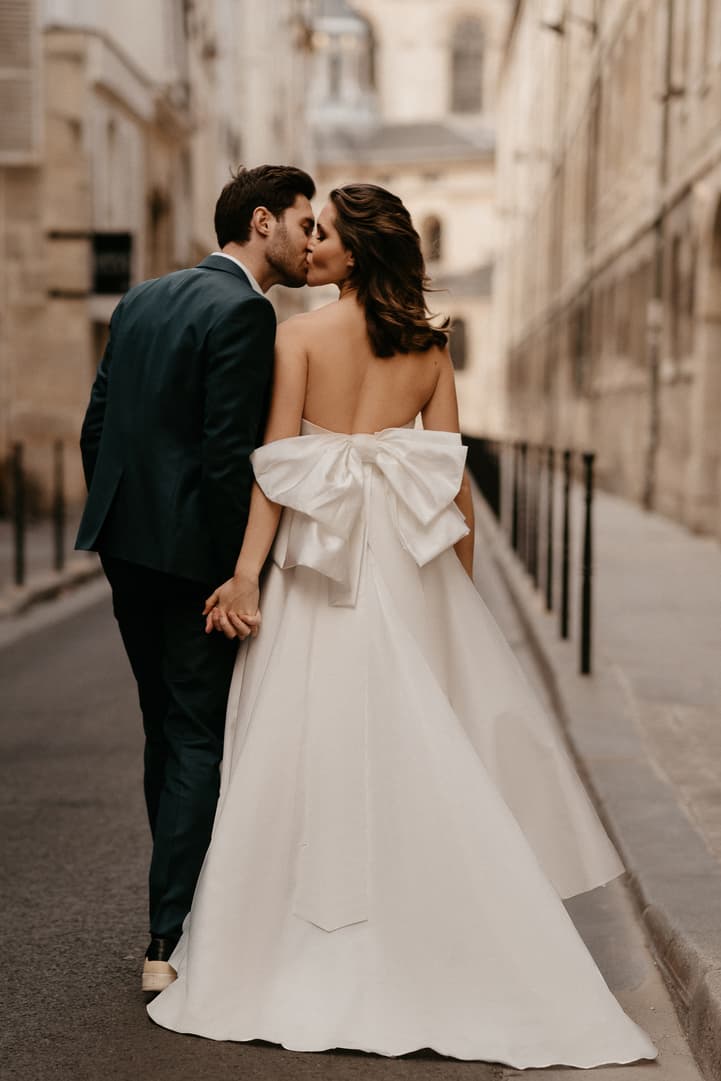 Chic bride wearing her wedding dress with big bow on the back