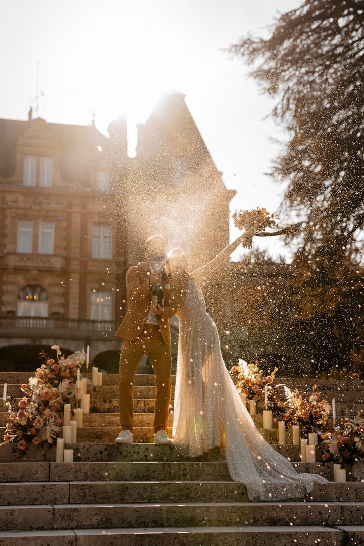 groom and bride celebrate with champagne popping
