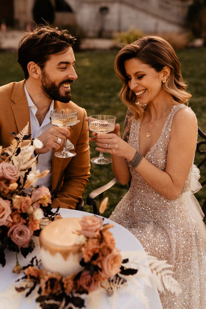couple intimate wedding celebration with cake and champagne