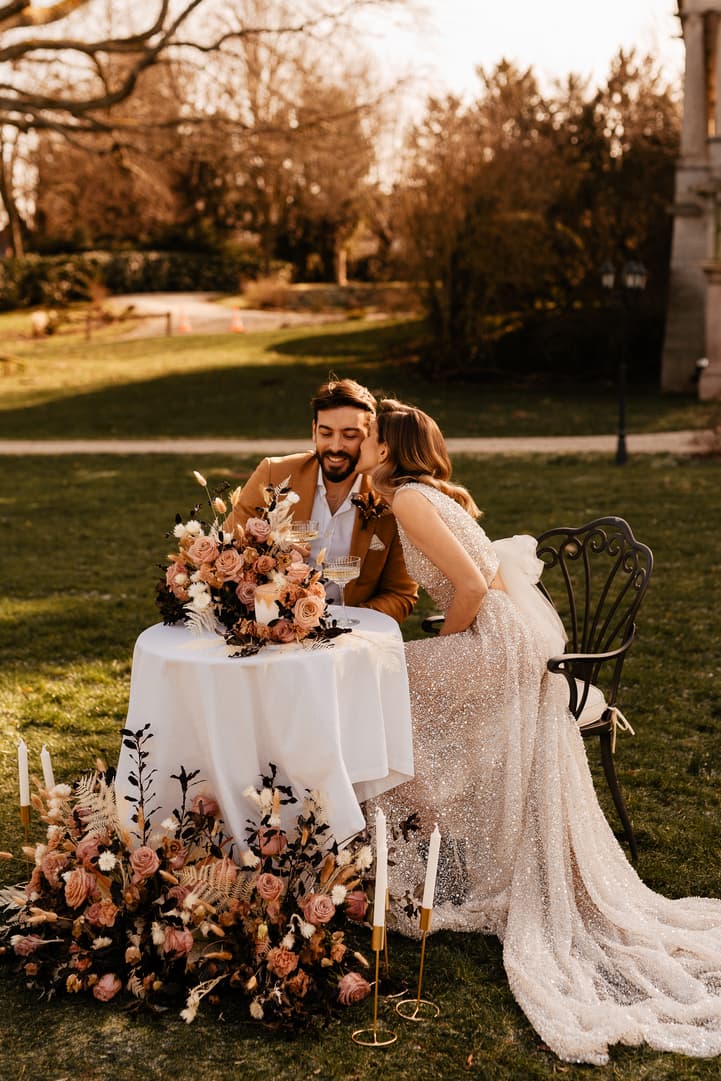 groom and bride kiss and celebration with cake and champagne