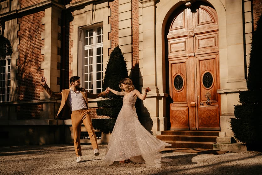 Couple dance in their elopement wedding in castle Bouffemont at golden hour of sunset