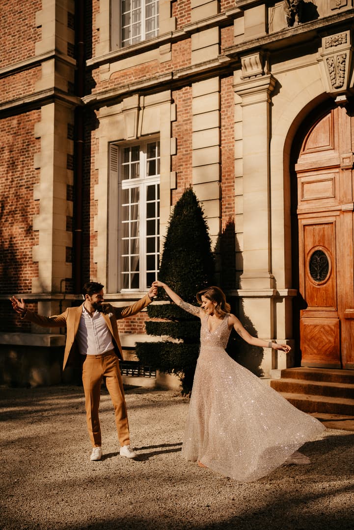 Couple dance in their elopement wedding in castle Bouffemont at golden hour of sunset