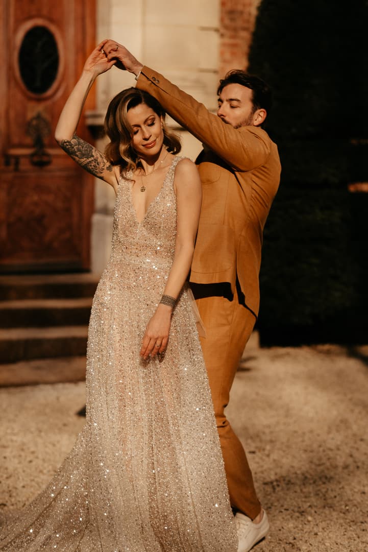 Couple dance in their elopement wedding in castle Bouffemont at golden hour of sunset