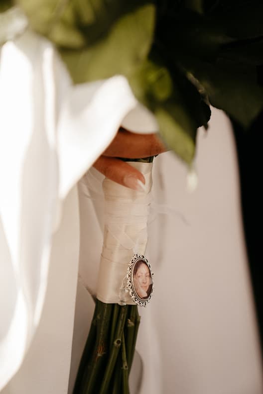 Wedding Details Pictures of Loved ones on Flower Bouquet