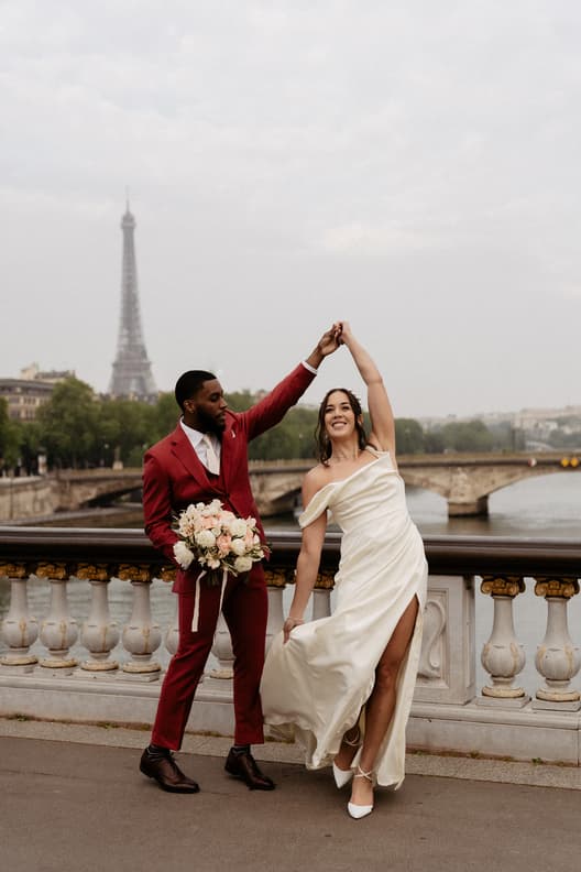 Couple shoot twirling on bridge with Eiffel Tower View
