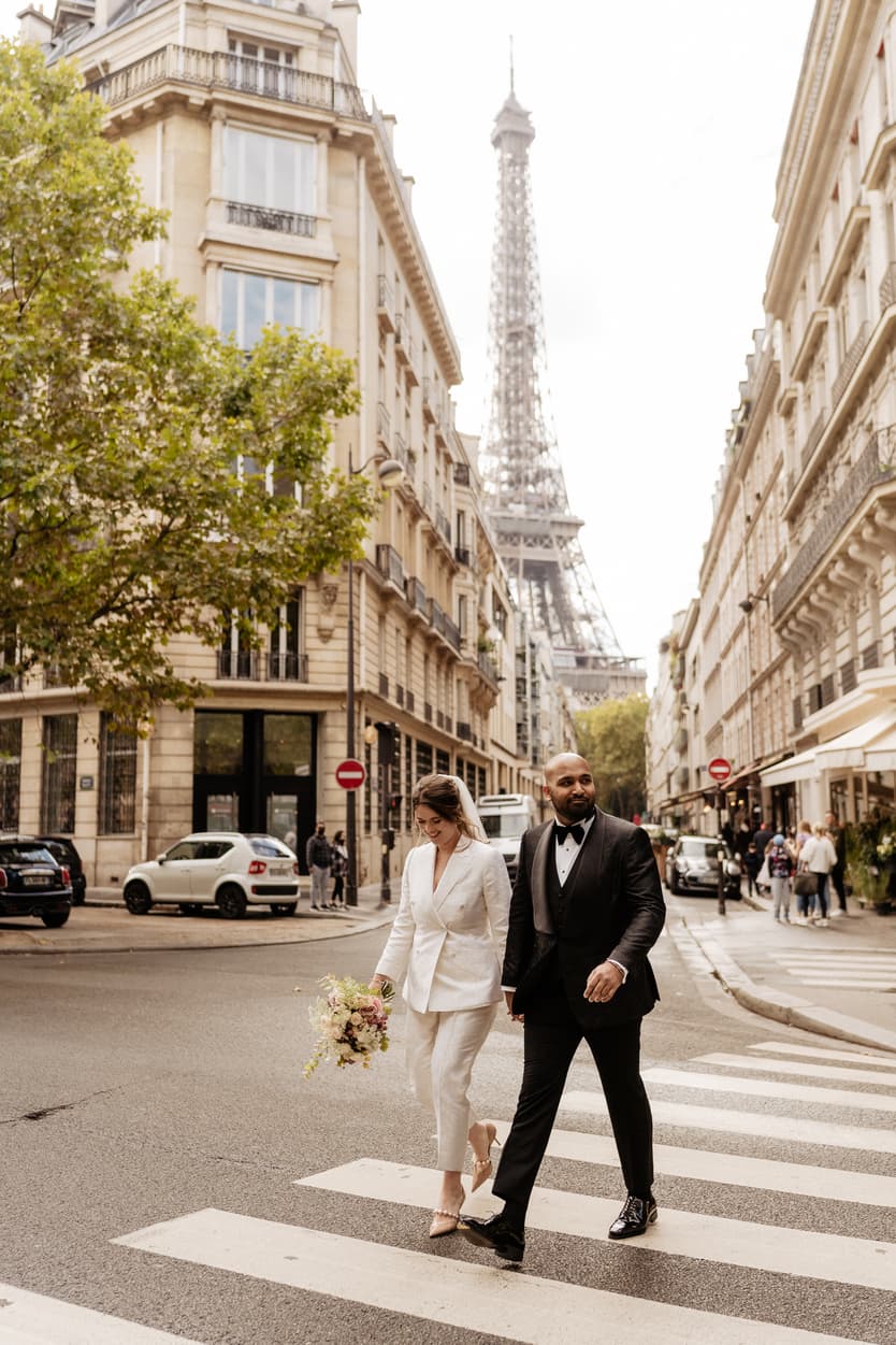 Paris Elopement Packages Elopement Photographer Videographer couple walking hand in hand with Eiffel Tower view