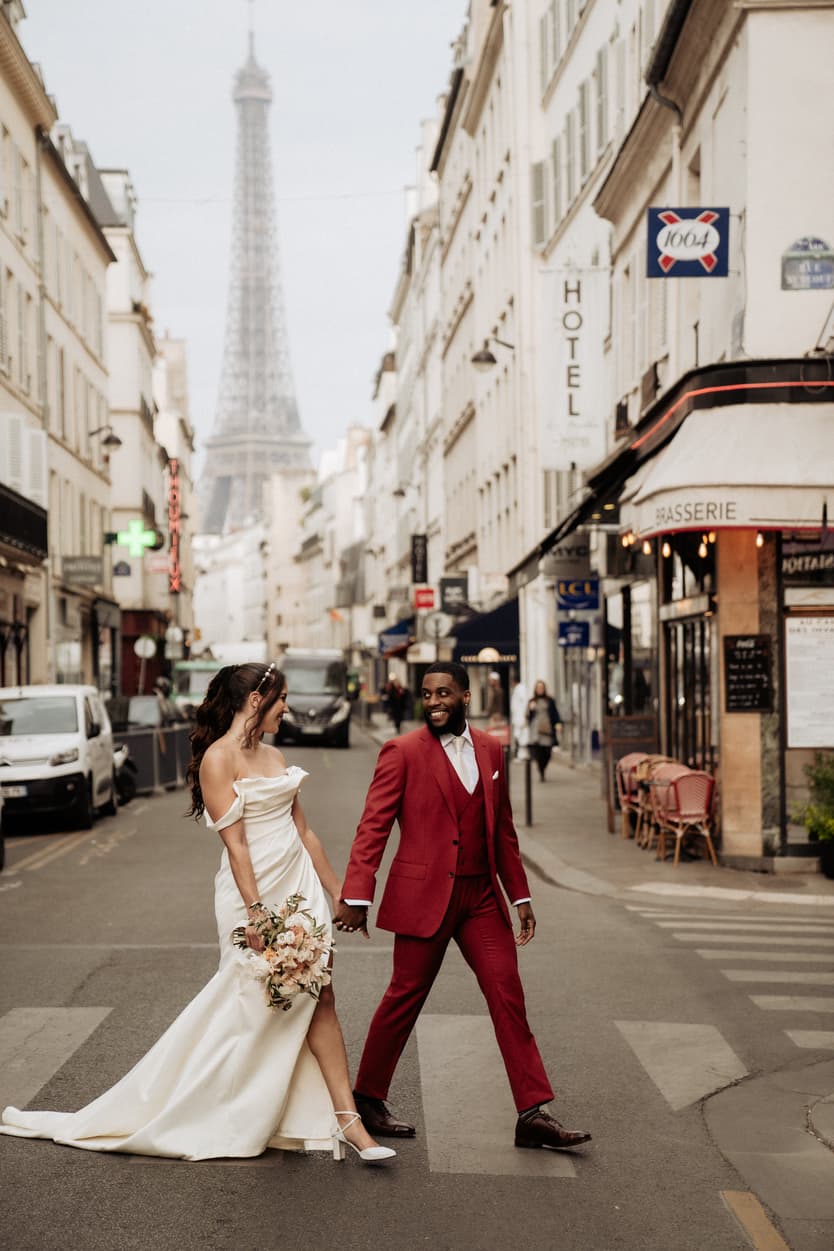 Paris Elopement Packages Elopement Photographer Videographer couple crossing street in Paris Eifferl Tower view