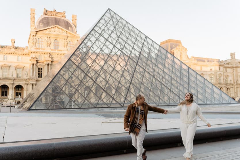 Paris Elopement Packages Elopement Photographer Videographer winter elopement couple running Louvre Paris 