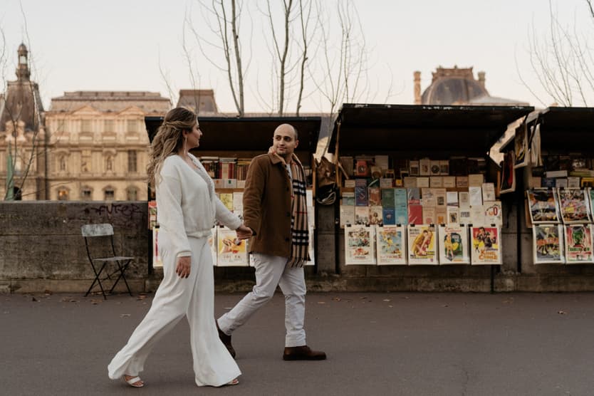 Paris Elopement Packages Elopement Photographer Videographer winter elopement couple walking Louvre Paris 