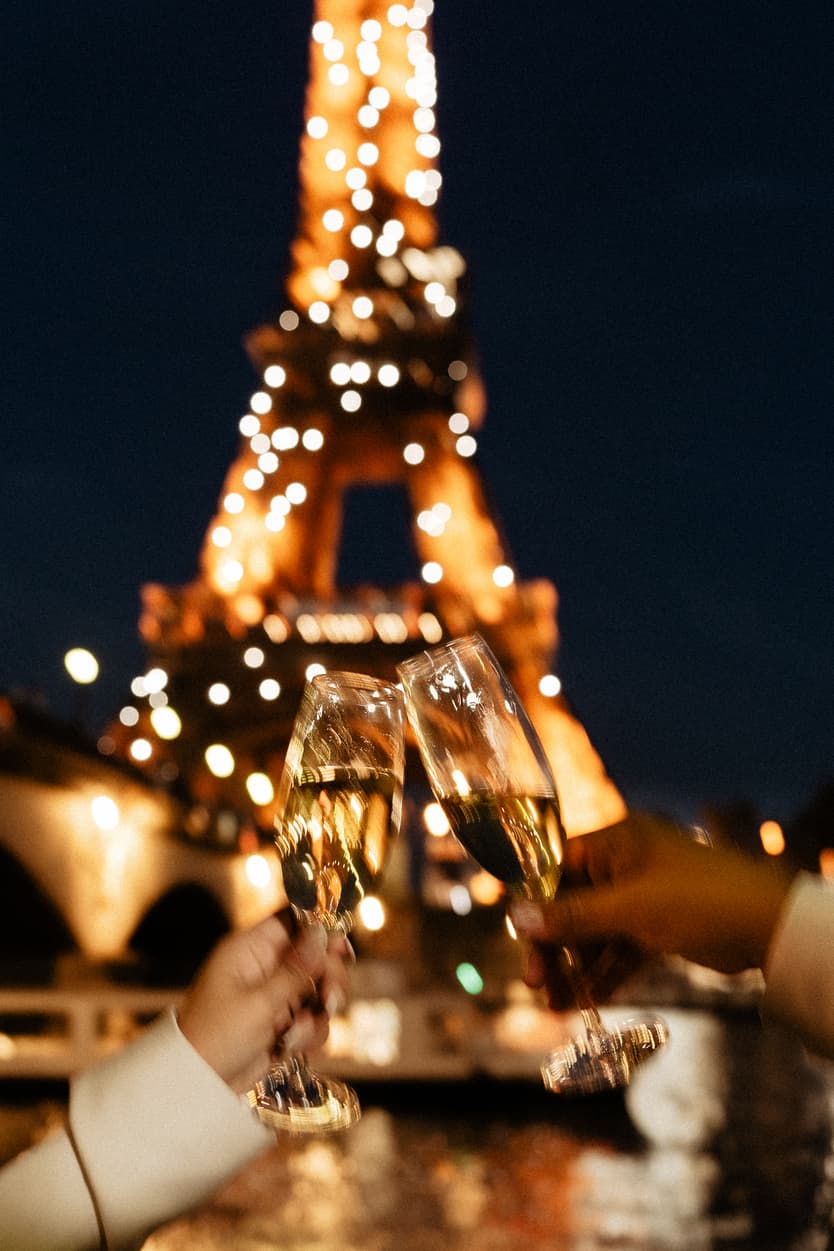 Paris Elopement Packages Elopement Photographer Videographer couple toasting Eiffel Tower night 