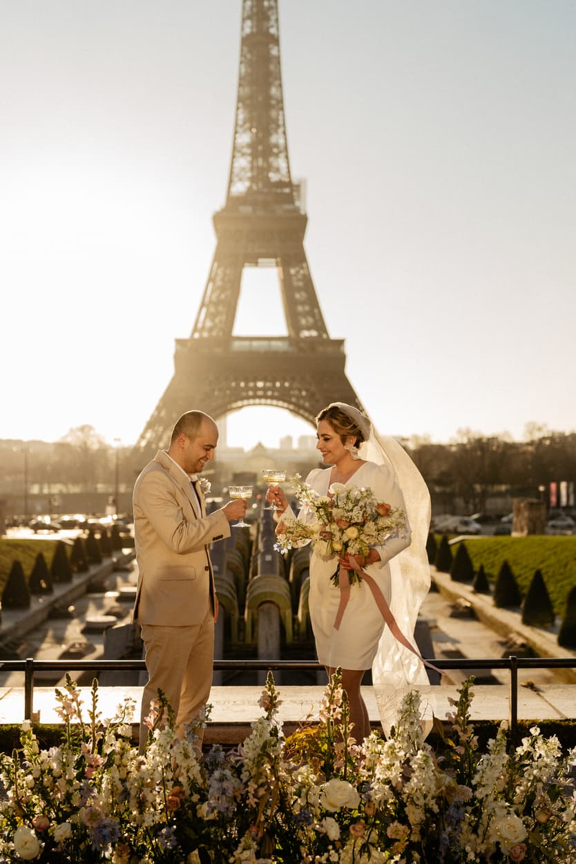 Paris Elopement Packages Elopement Photographer Videographer winter elopement couple ceremony wine flower decoration Eiffel Tower view 