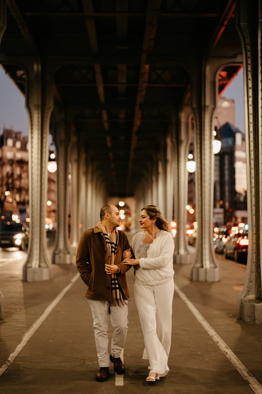 Paris Elopement Packages Elopement Photographer Videographer winter elopement couple walking  Bir Hakeim Paris 