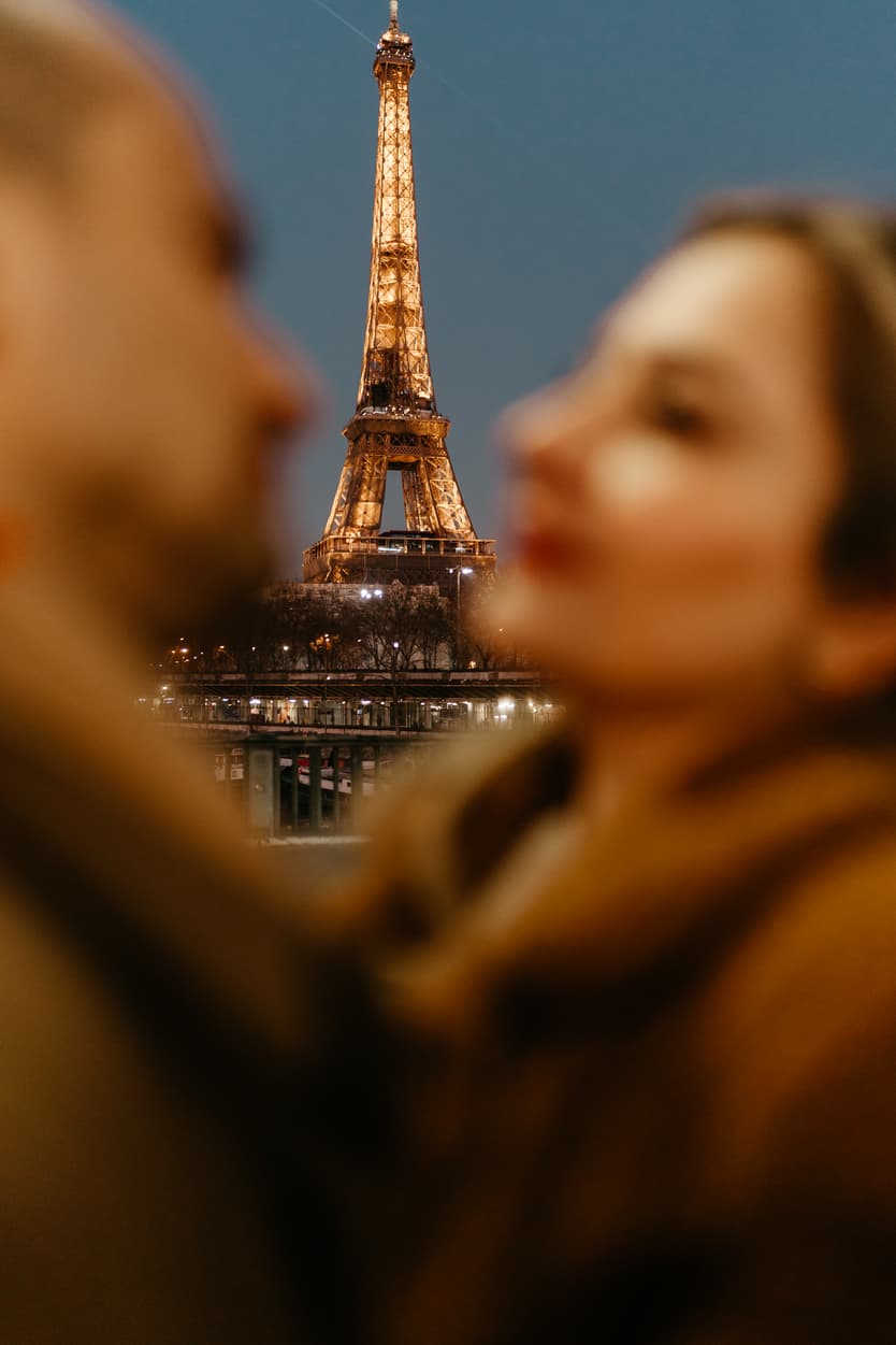 Paris Elopement Packages Elopement Photographer Videographer winter elopement couple hugging Eiffel Tower view Bir Hakeim