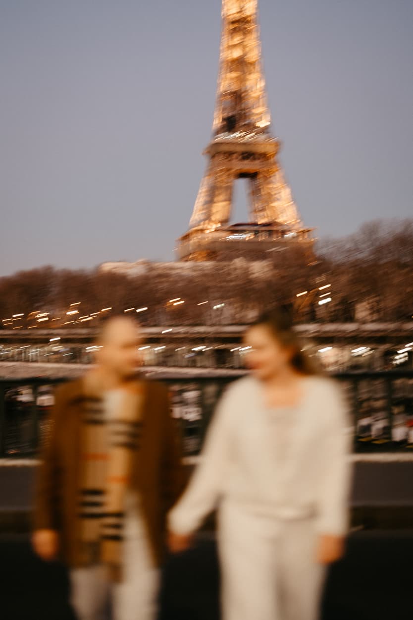 Paris Elopement Packages Elopement Photographer Videographer winter elopement couple walking Eiffel Tower view Bir Hakeim