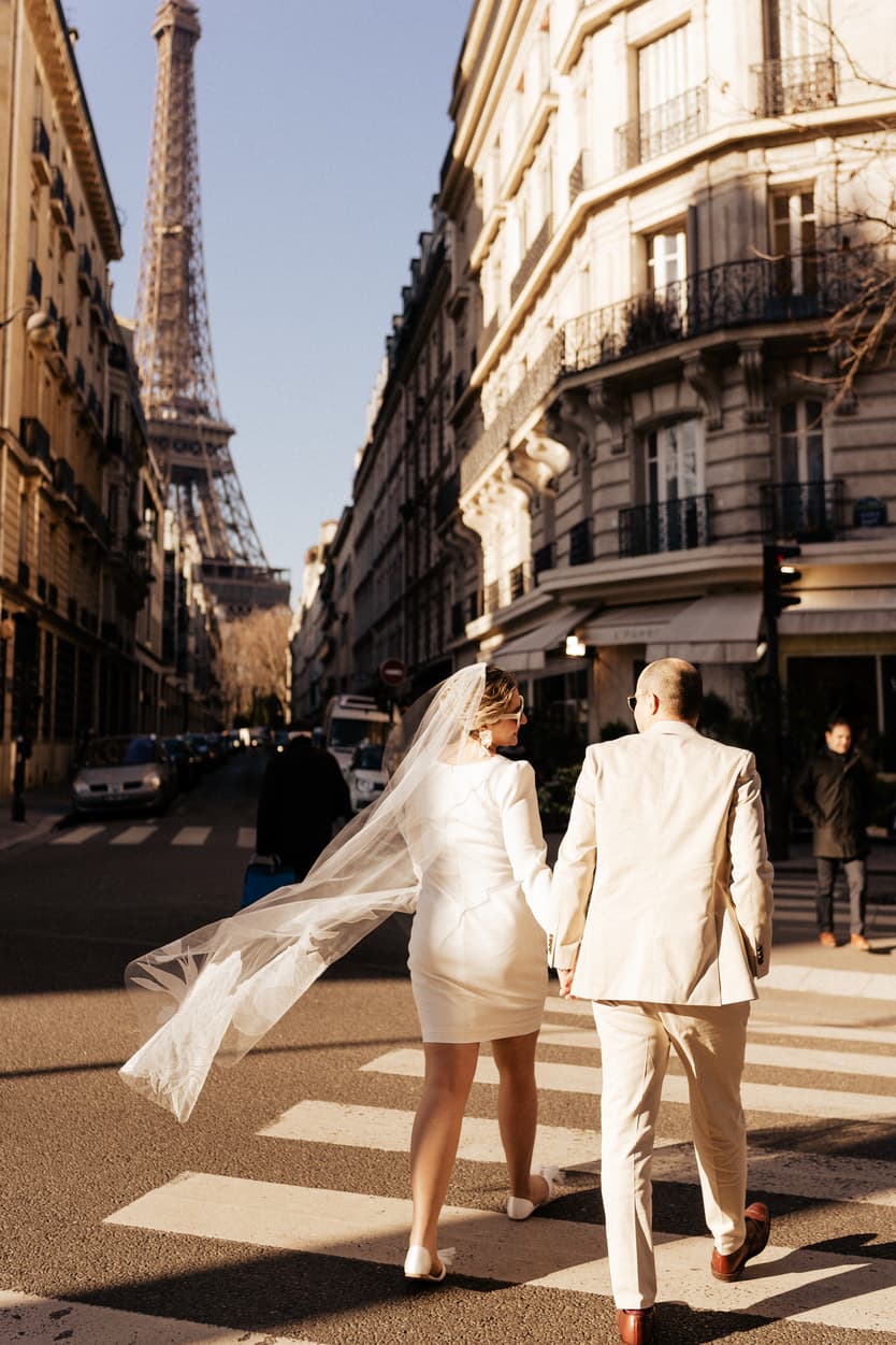 Paris Elopement Packages Elopement Photographer Videographer winter elopement couple in the street crossing Eiffel Tower view 