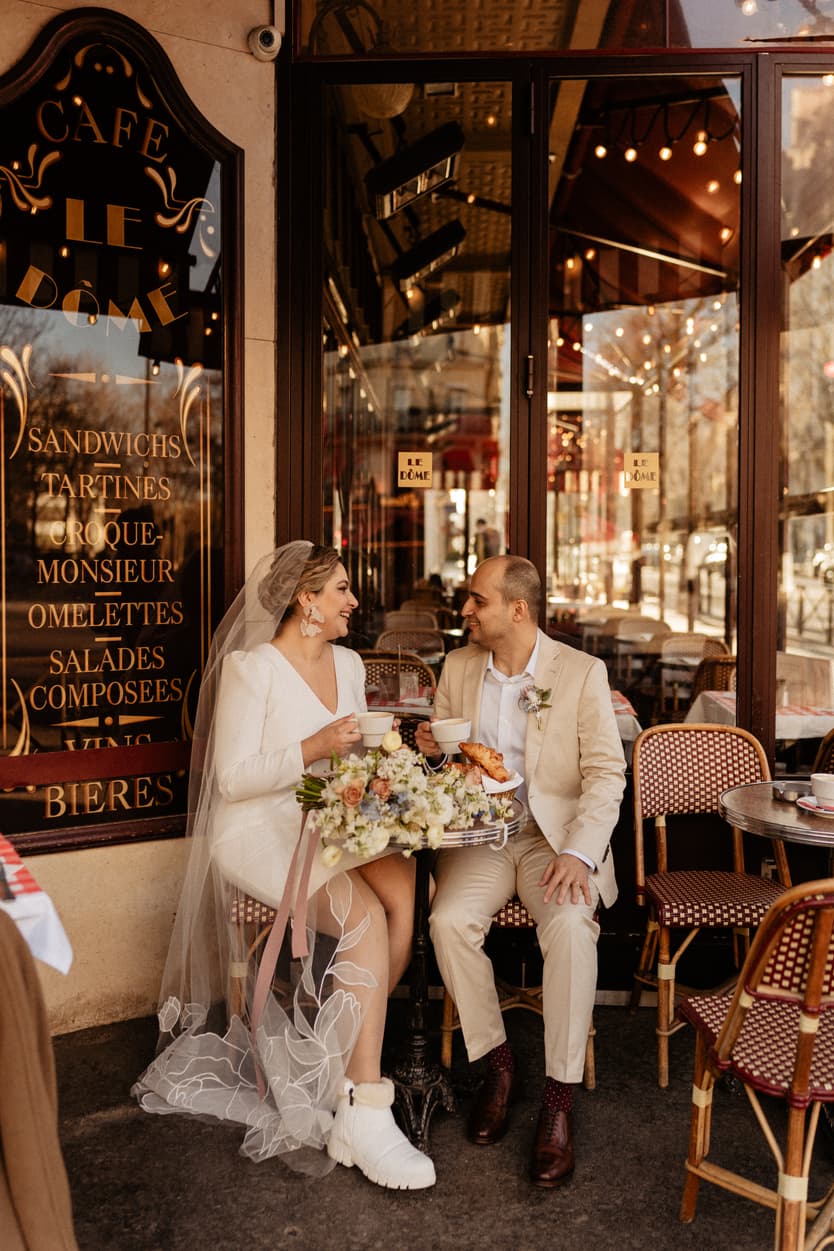 Paris Elopement Packages Elopement Photographer Videographer winter elopement couple sitting at cafè Paris