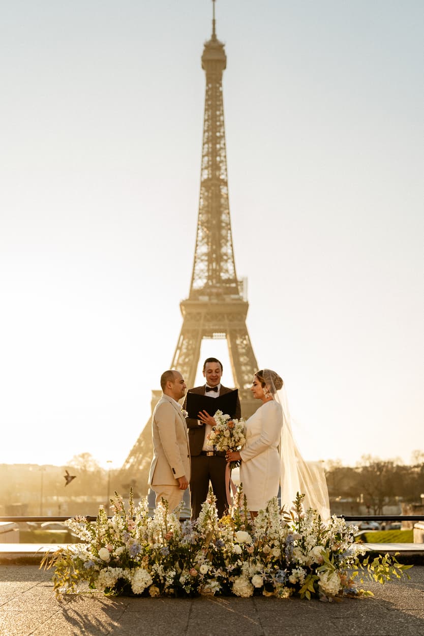 Paris Elopement Packages Elopement Photographer Videographer winter elopement couple ceremony flower decoration Eiffel Tower view 