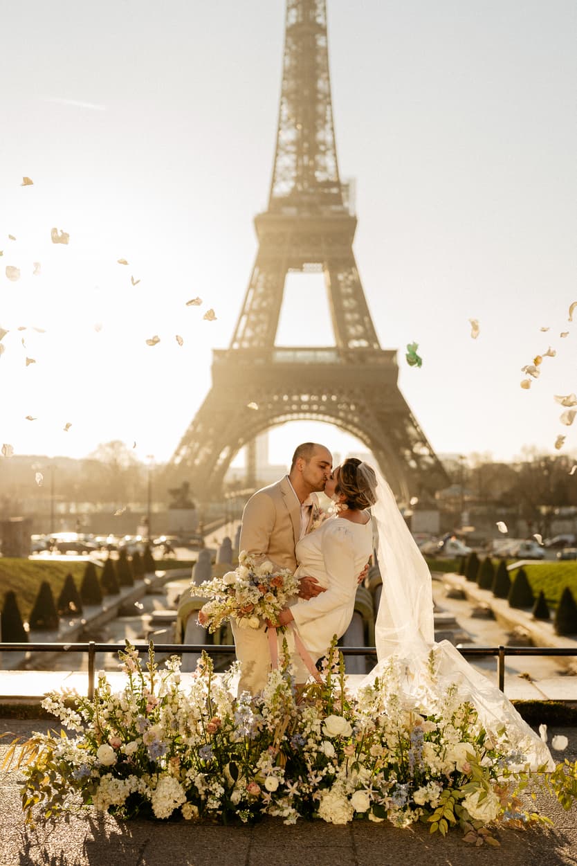 Paris Elopement Packages Elopement Photographer Videographer winter elopement couple ceremony flower decoration Eiffel Tower view petal toss
