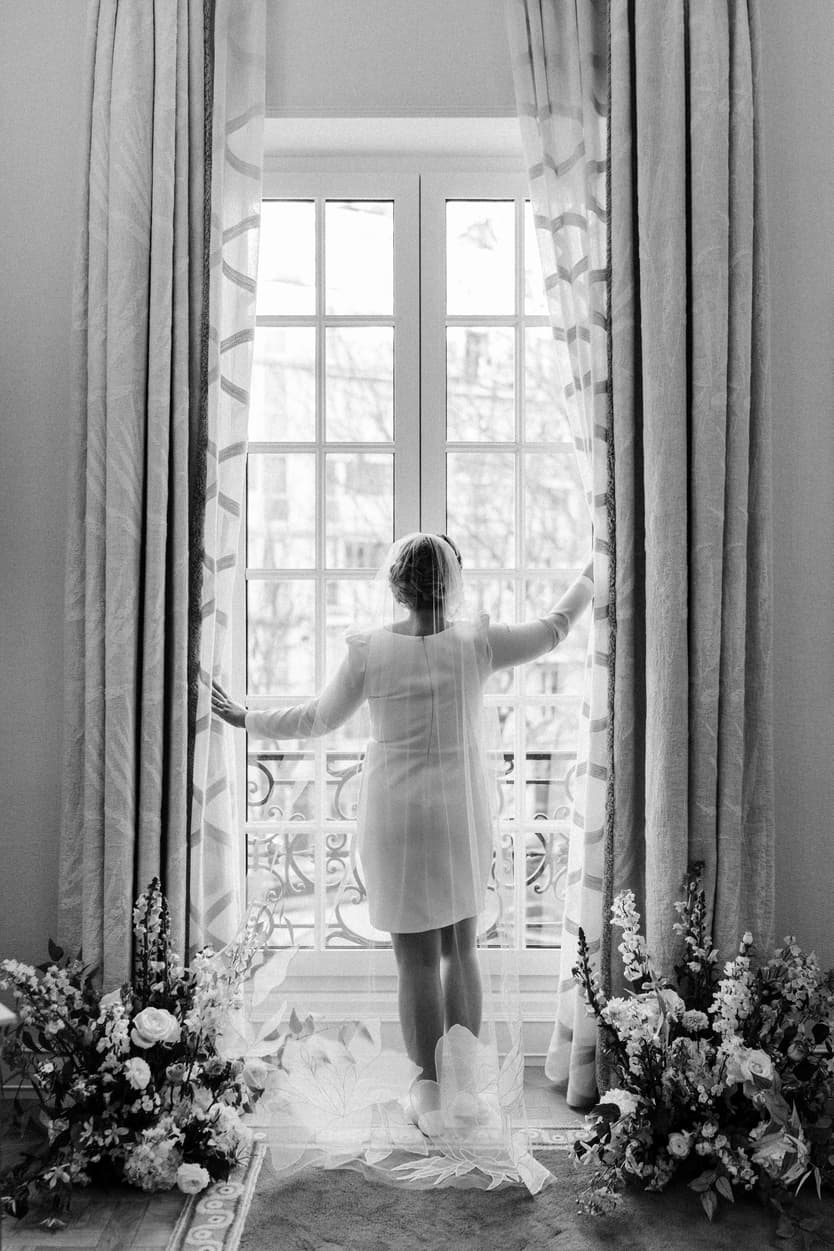 Paris Elopement Packages Elopement Photographer Videographer winter elopement bride at the window with veil 