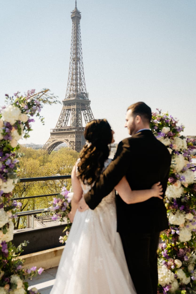 Destination Purple wedding elopement at Shangri-La Hotel Paris private rooftop Eiffel Tower view  floral arch and couple 