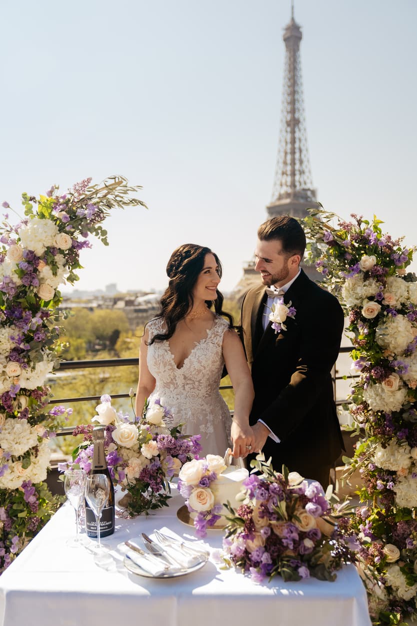 Destination Purple wedding elopement at Shangri-La Hotel Paris private rooftop Eiffel Tower view couple cutting cake 