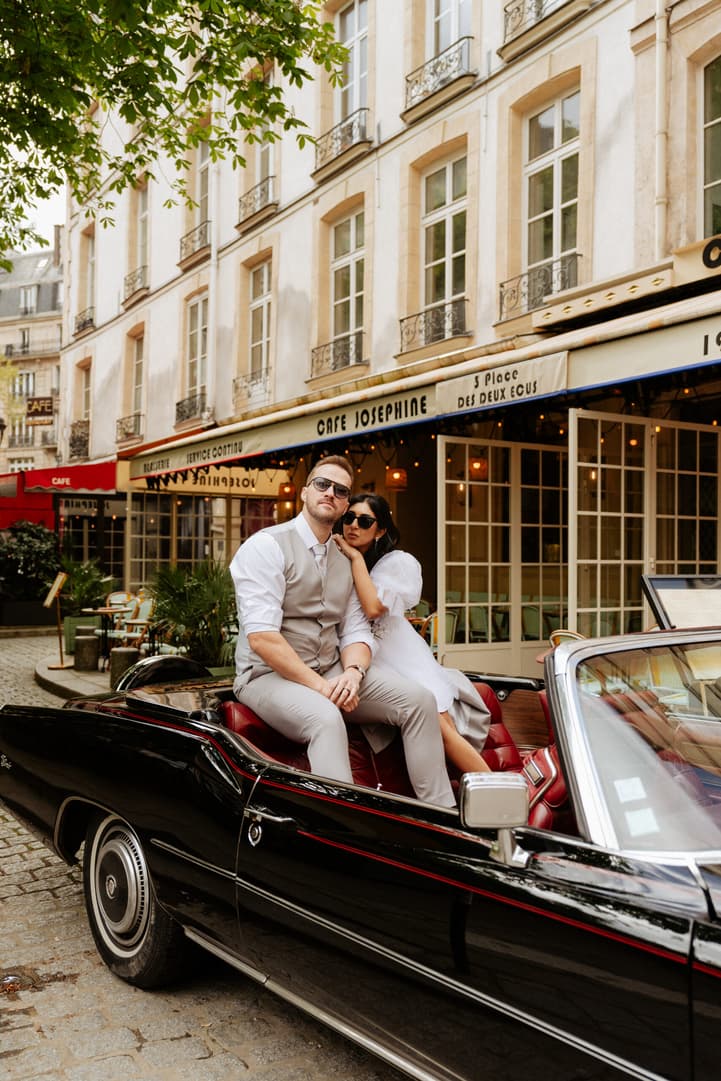 Paris Elopement Videographer Couple sitting on vintage car elopement paris