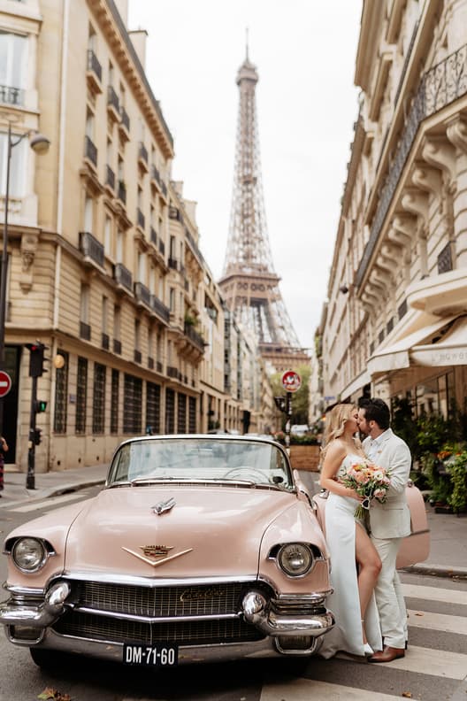 couple kissing with vintage car in front of Eiffel tower street