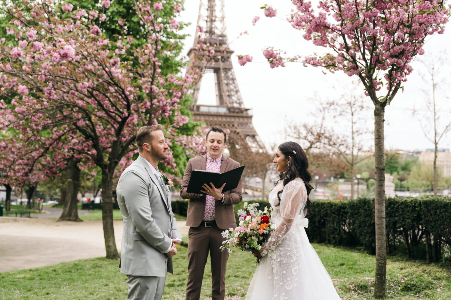 Bride and groom exchange vows at Trocadero with Eiffel Tower view, Paris elopement cherry blossom