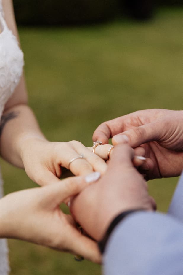 A&M exchanging rings, a close-up of their hands