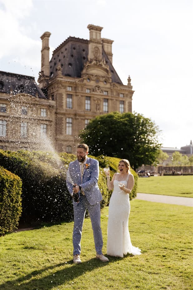 couple with champagne pop elopement wedding in Paris