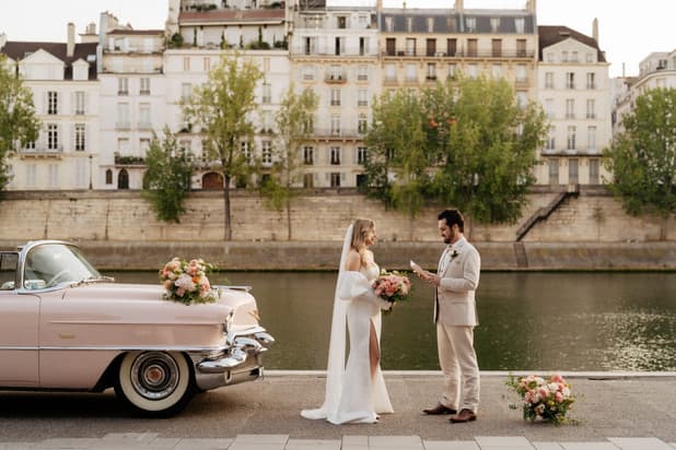 Bride and groom exchange vows at Ile Saint Louis, Paris elopement with pink vintage car 