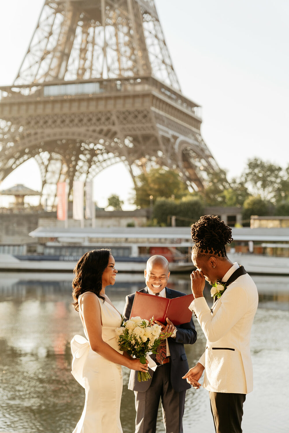 paris elopement first look by the Seine river sunrise groom crying officiant