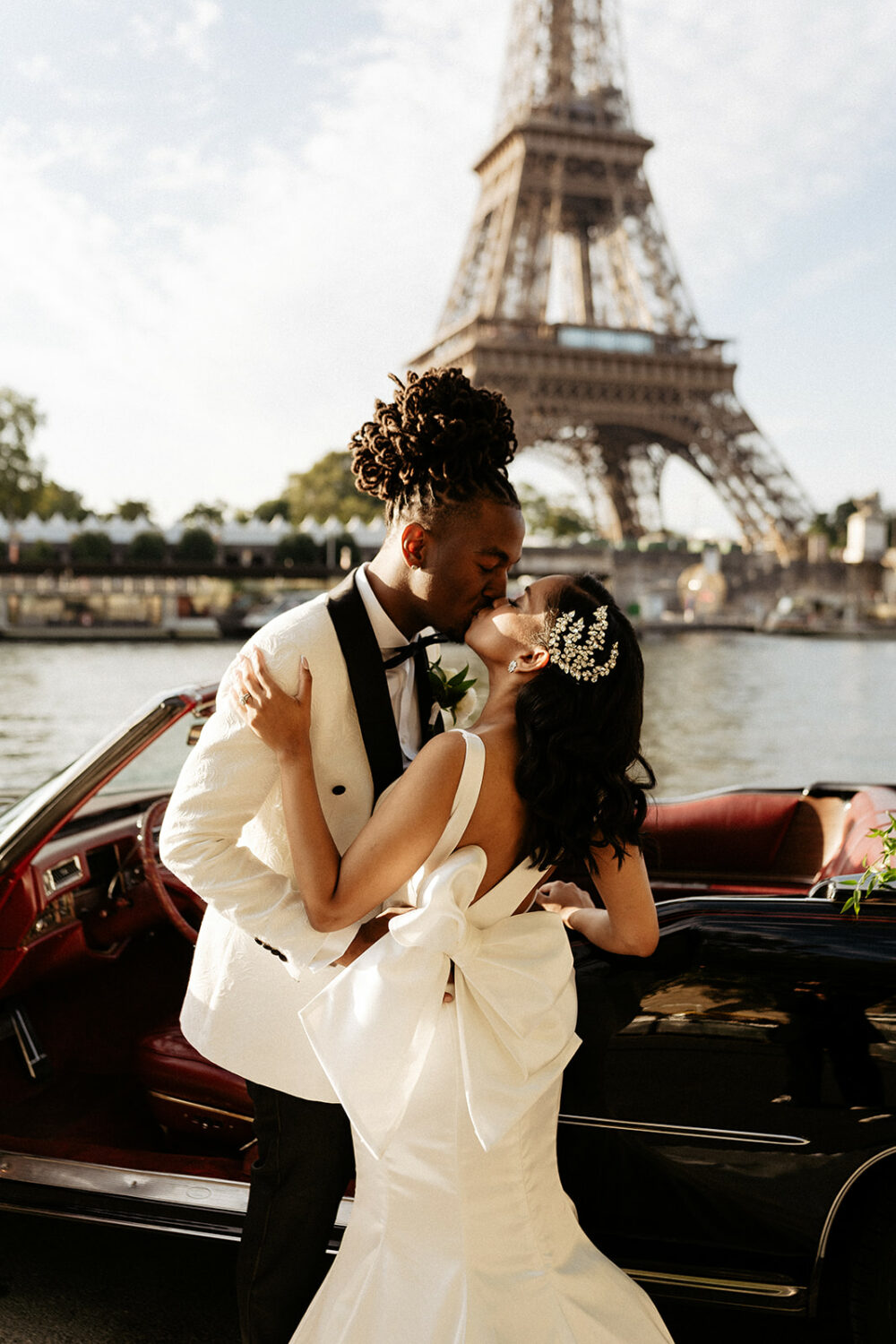 Bride wearing pnina Tornai dress with a statement bow Paris elopement with Eiffel tower