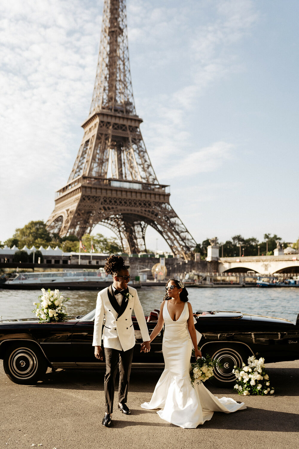 couple walking in front of vintage car for their wedding elopement in Paris with Eiffel tower