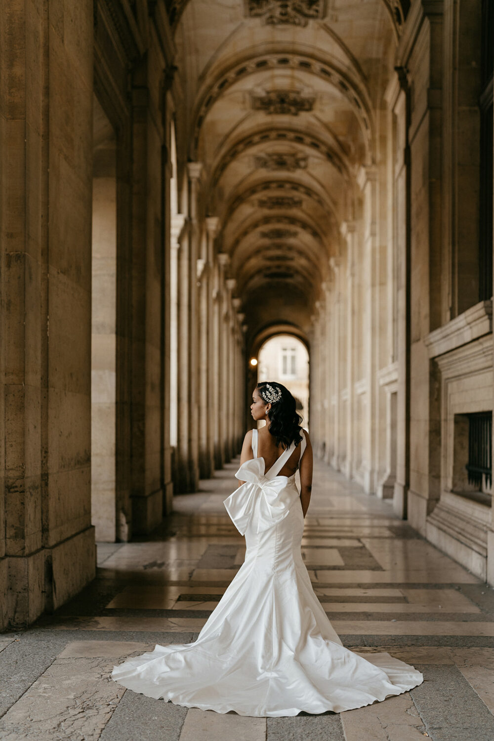 Bride wearing pnina Tornai dress with a statement bow