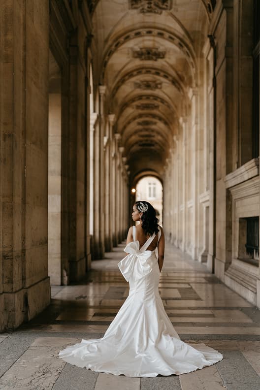 Bride wearing pnina Tornai dress with a statement bow