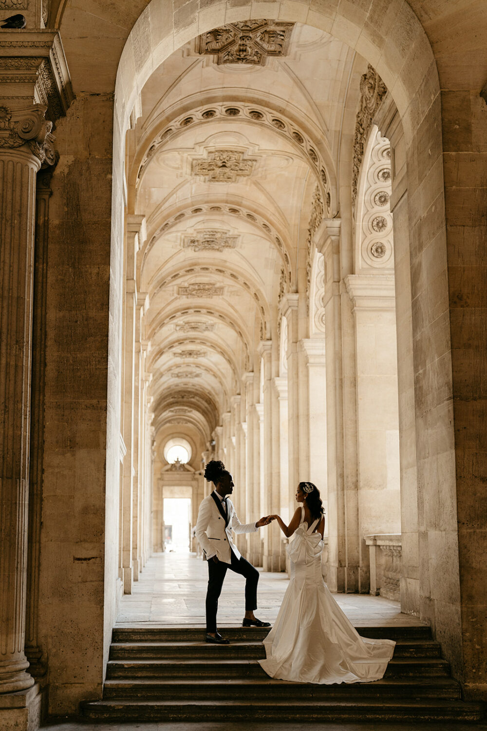 Bride wearing pnina Tornai dress with a statement bow at the Louvre museum