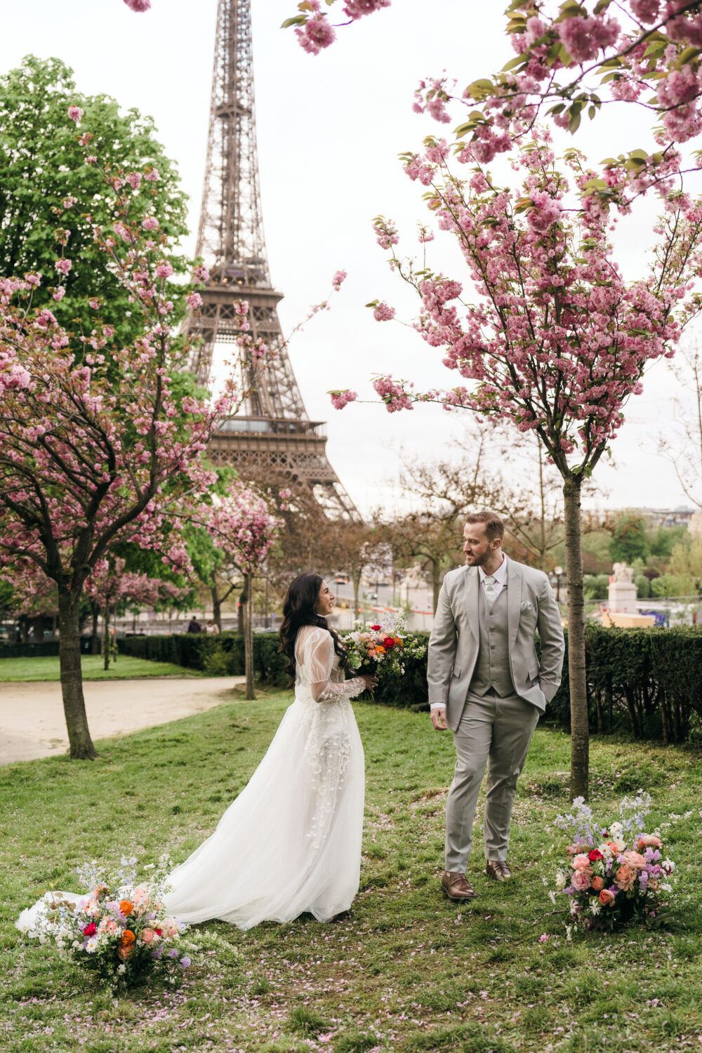 Bride and groom doing first look Paris Elopement cherry blossom Trocadero Eiffel Tower