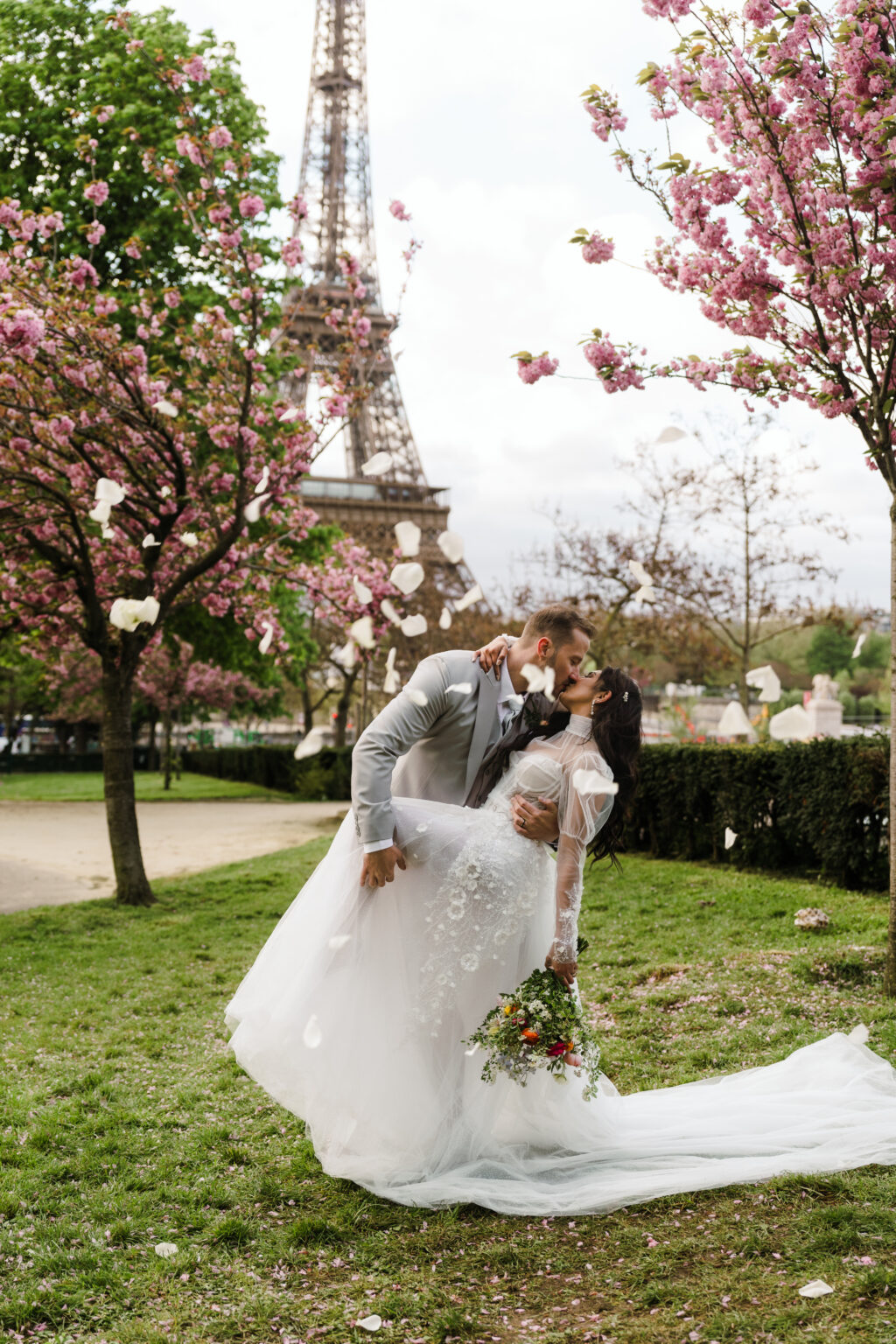 Bride and groom kissing Paris elopement cherry blossom spring
