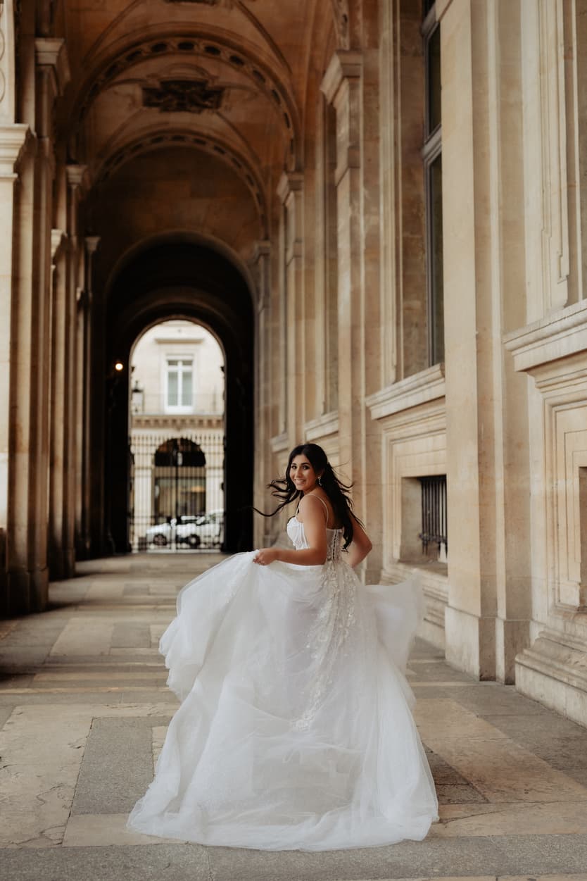 Bride running Paris elopement Louvre