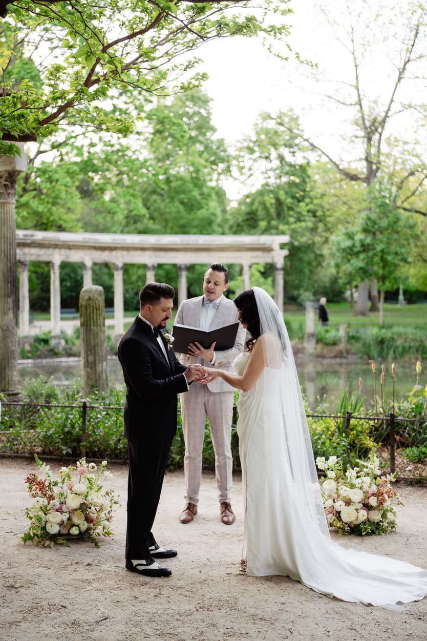 An officiant marrying a couple in a Paris garden