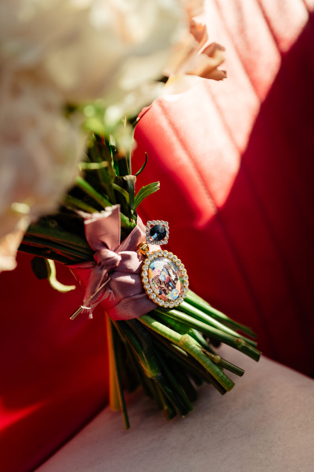 A brooch of dogs in a pink vintage car