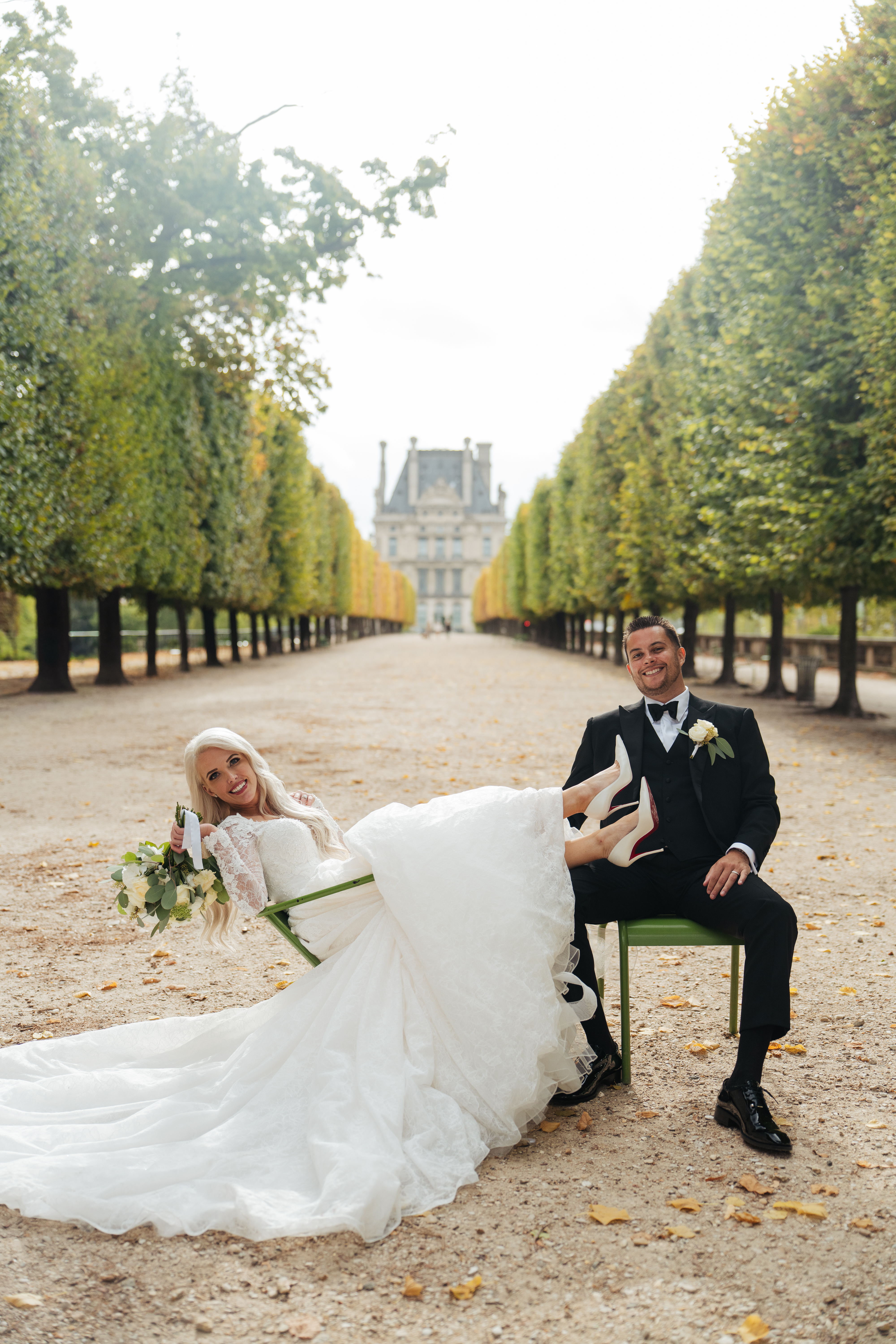 wedding couple sitting on the chairs at Tuileries garden having fun