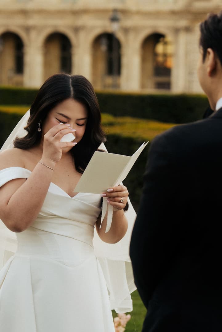 Nancy in tears as Jason reads his vows during their sunrise elopement ceremony at the Louvre