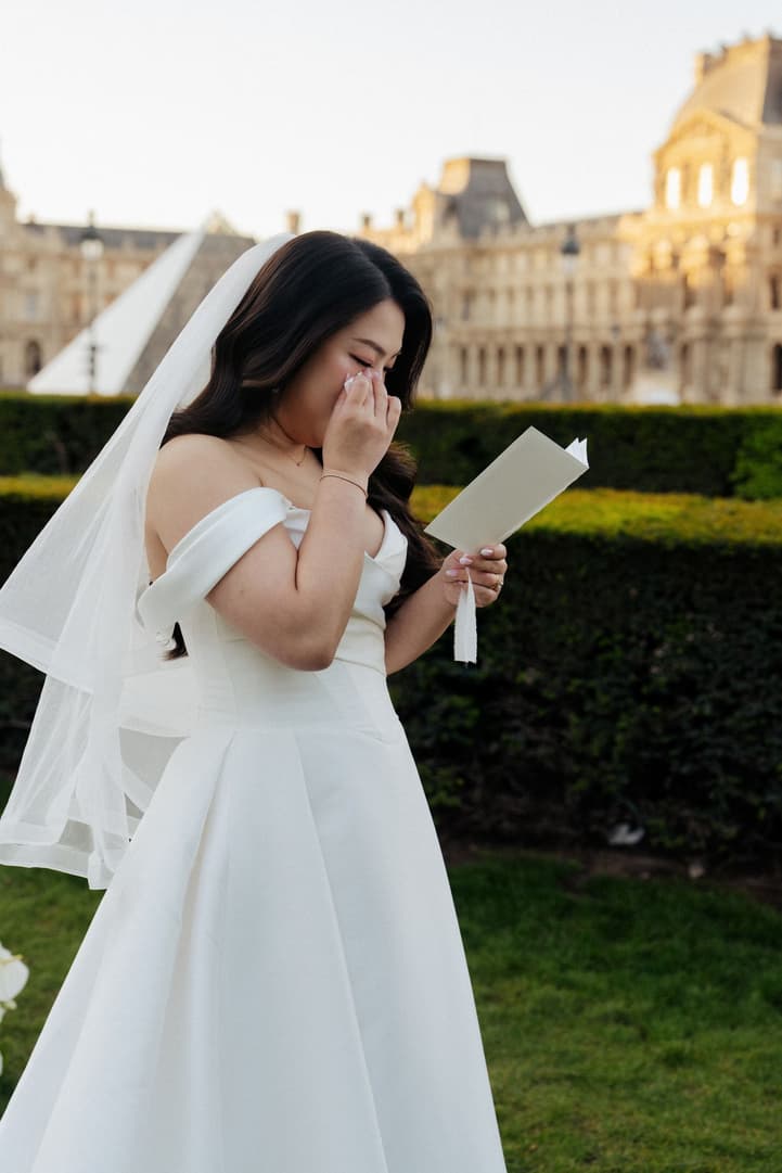Nancy wiping away a tear while reading her vows to Jason